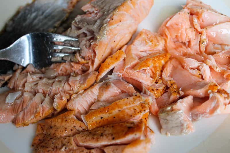 breaking the salmon with fork